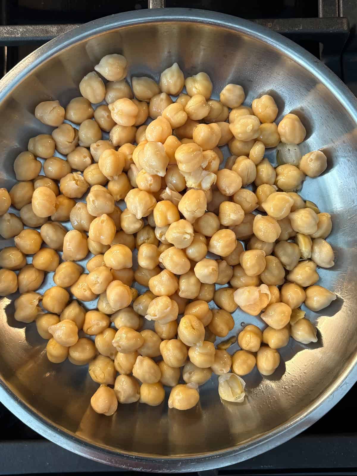 Chickpeas in a pan, sautéing.