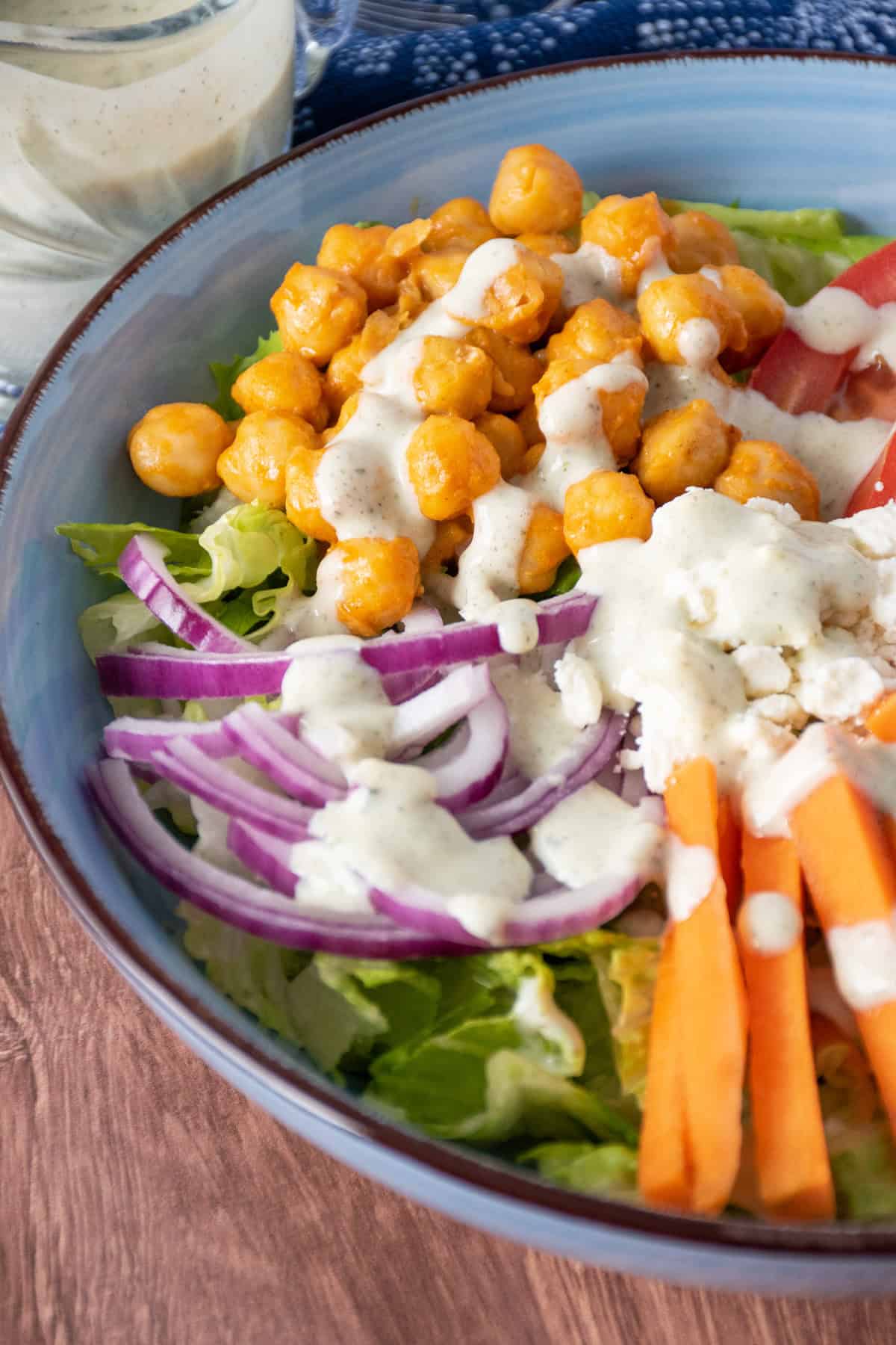 Close up of salad with ranch dressing drizzled on.