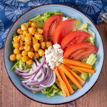 Overhead shot of a bowl of salad before being dressed.