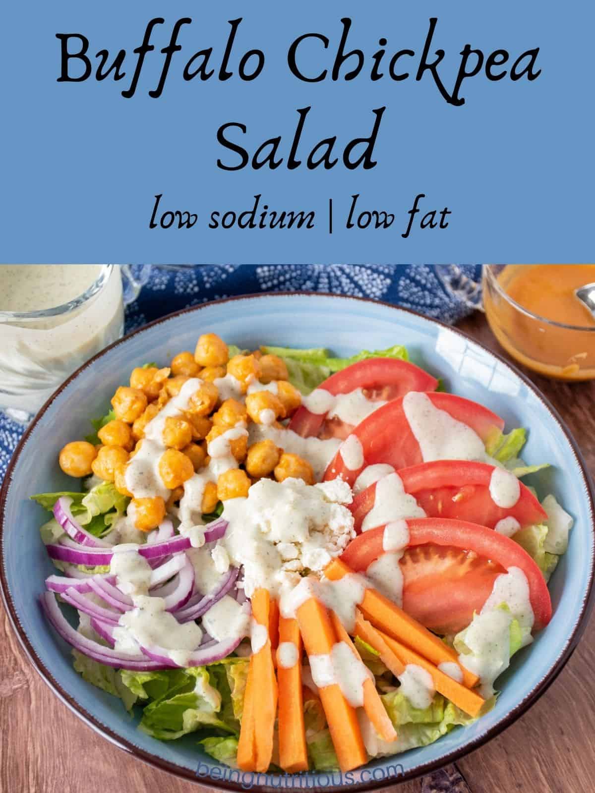 Salad in a bowl, drizzled with ranch dressing. Text overlay: Buffalo Chickpea Salad; low sodium, low fat.